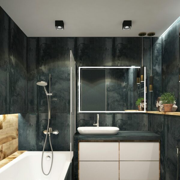 A contemporary bathroom showcasing black marble walls, clean lines, and modern fixtures, exuding luxury and style.