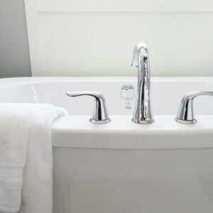 Clean and modern white bathtub with chrome fixtures, perfect for sleek interior design.