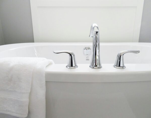 Clean and modern white bathtub with chrome fixtures, perfect for sleek interior design.